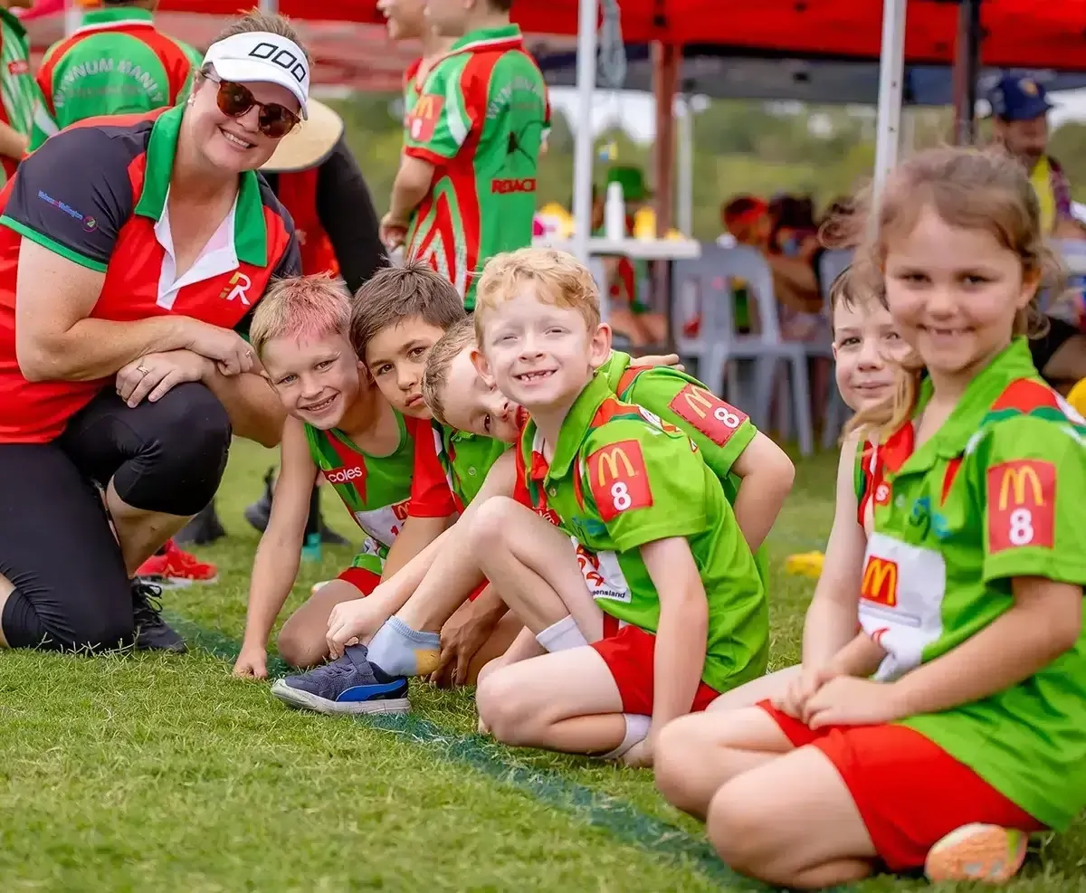 Junior Sports Team Smiling with Coach at Local Event Junior Sports Team