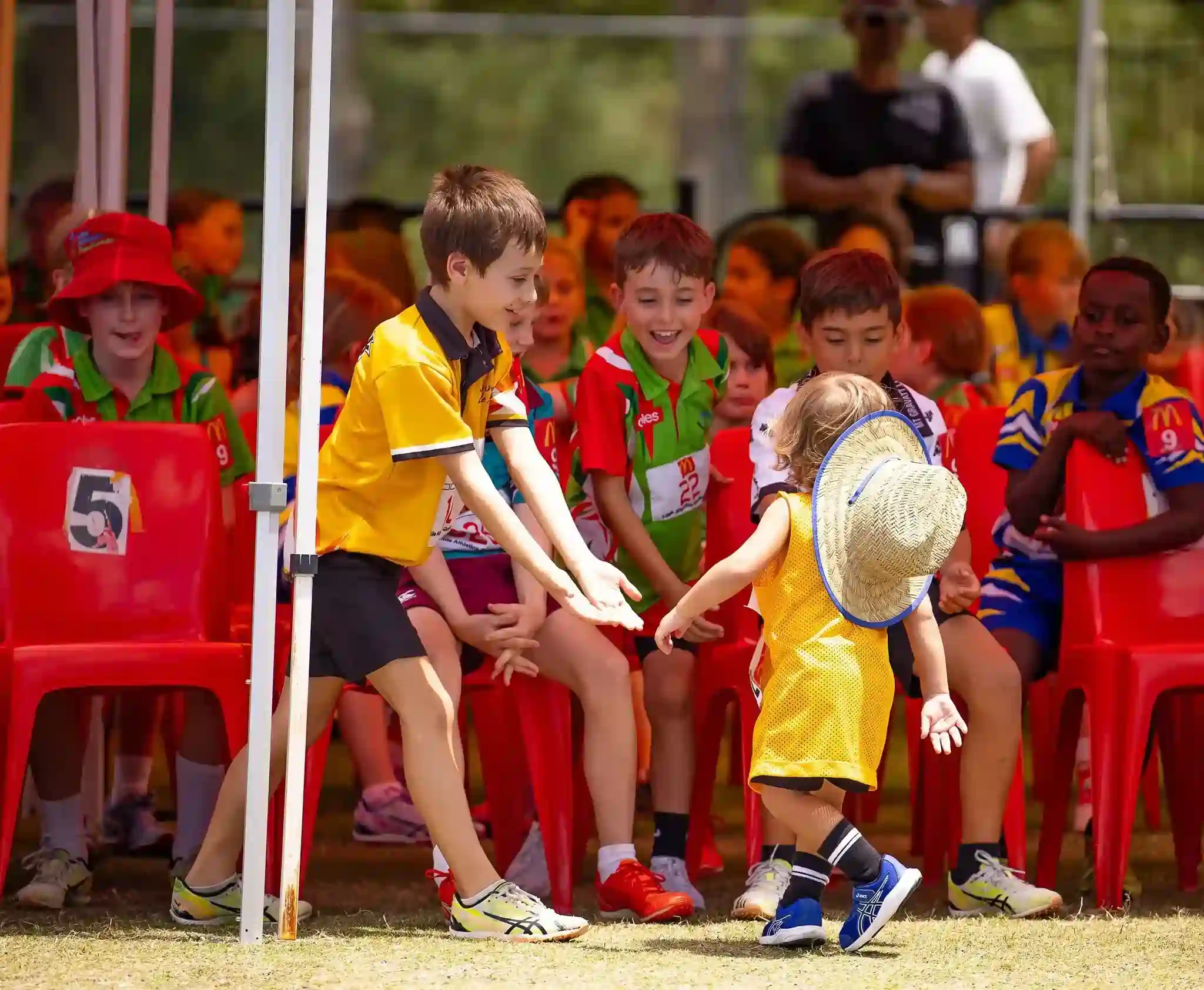 Older Child Welcomes Toddler During Junior Sports Ceremony Junior Sports Ceremony