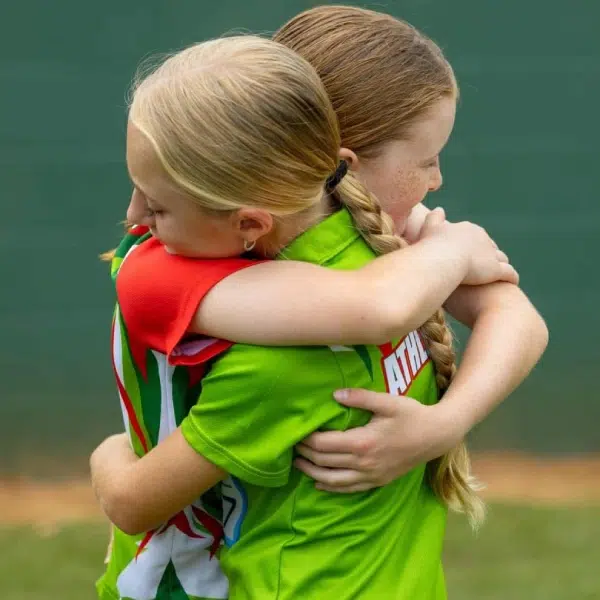 Little athletes hugging Little athletes hugging